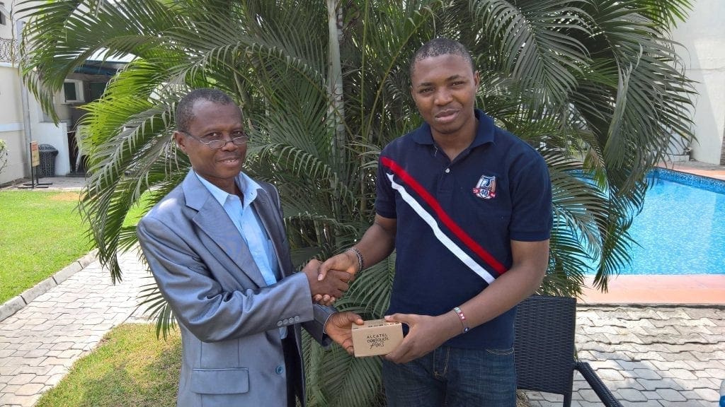 Olusola Tomiwa receiving the Alcatel Oneouch Pixi 3 smartphone won by Gloria Ogbonaya from Wale Oguntokun of Techsmart.ng