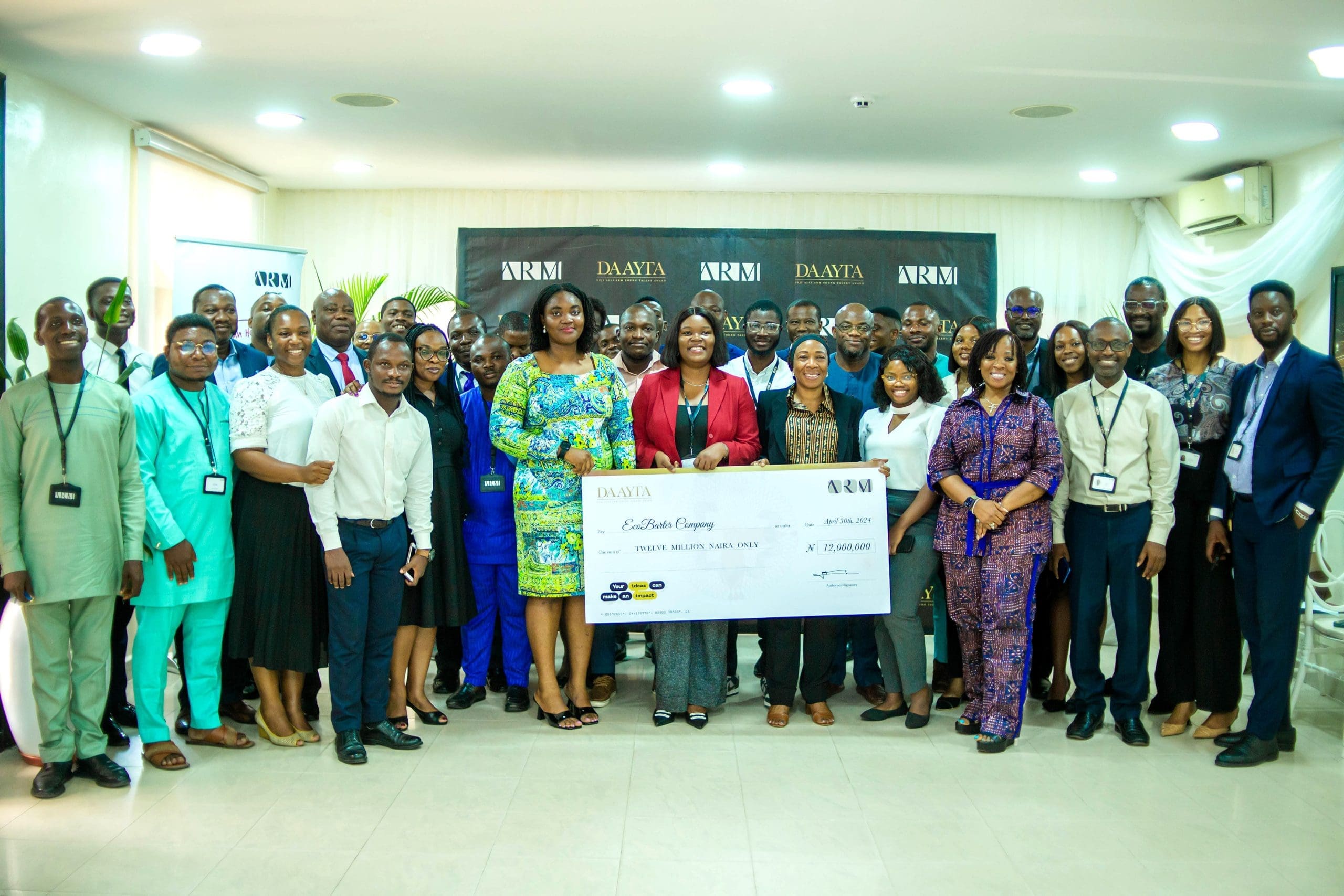 The winner of DAAYTA 2024 Rita Idehai of EcoBarter with the ARM team scaled